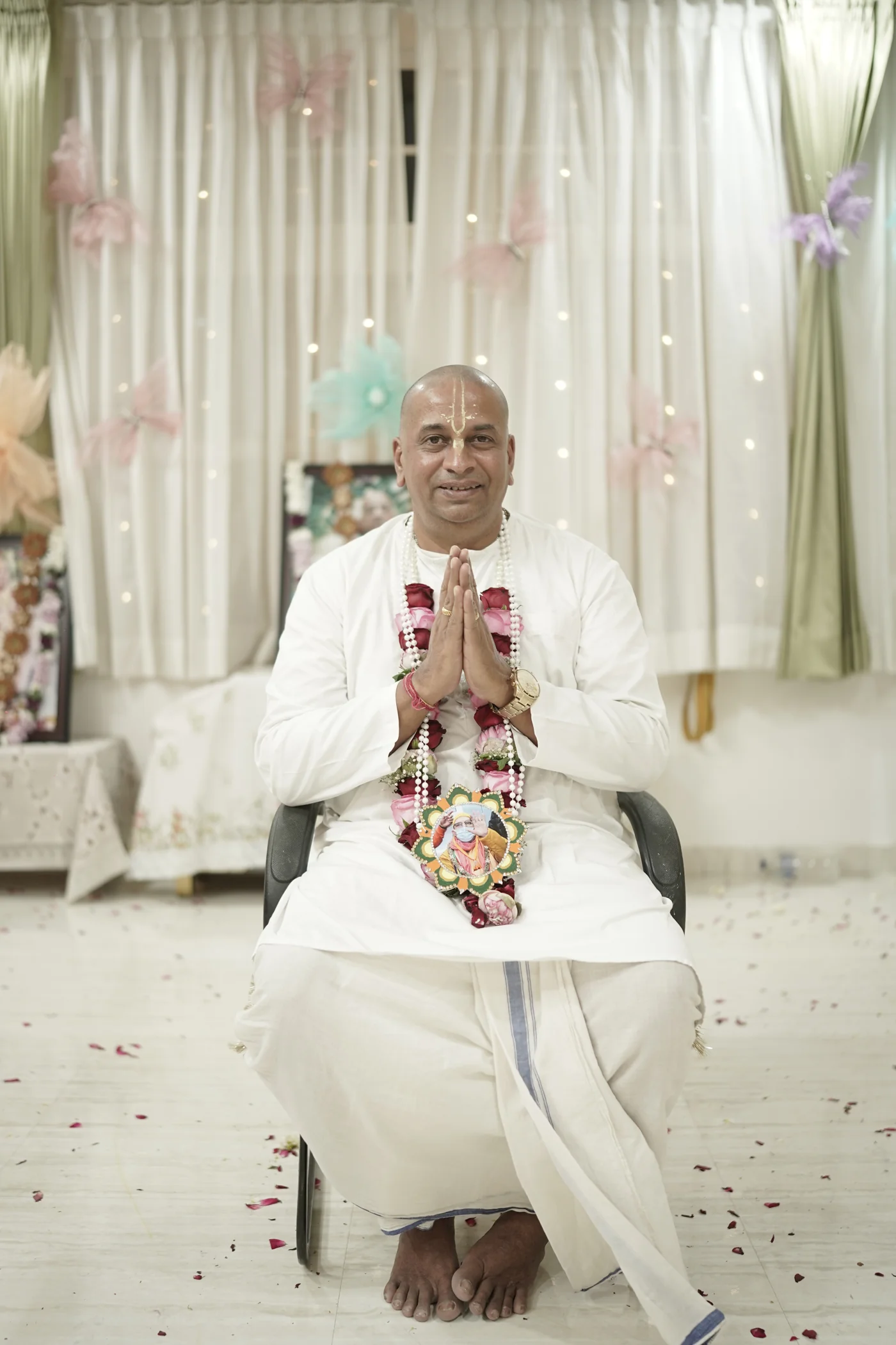 Caitanya Avatāri Dāsa seated with folded hands